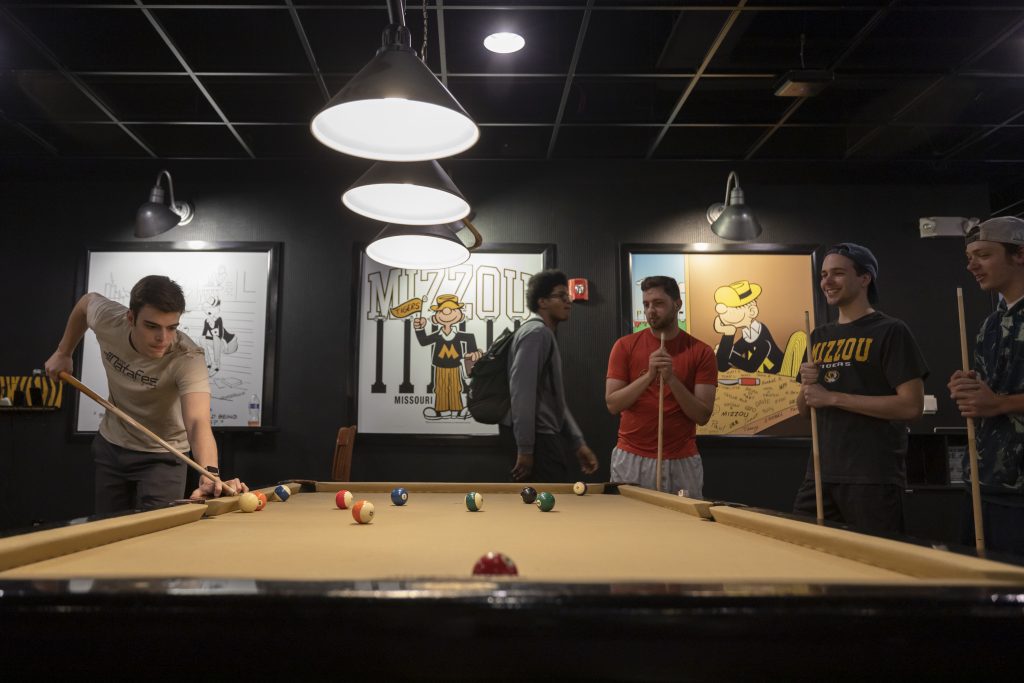 Students play pool in The Shack at the University of Missouri