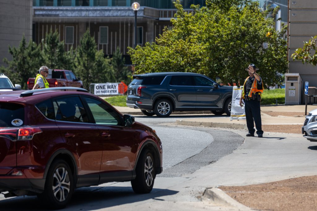 A person directs cars on a street
