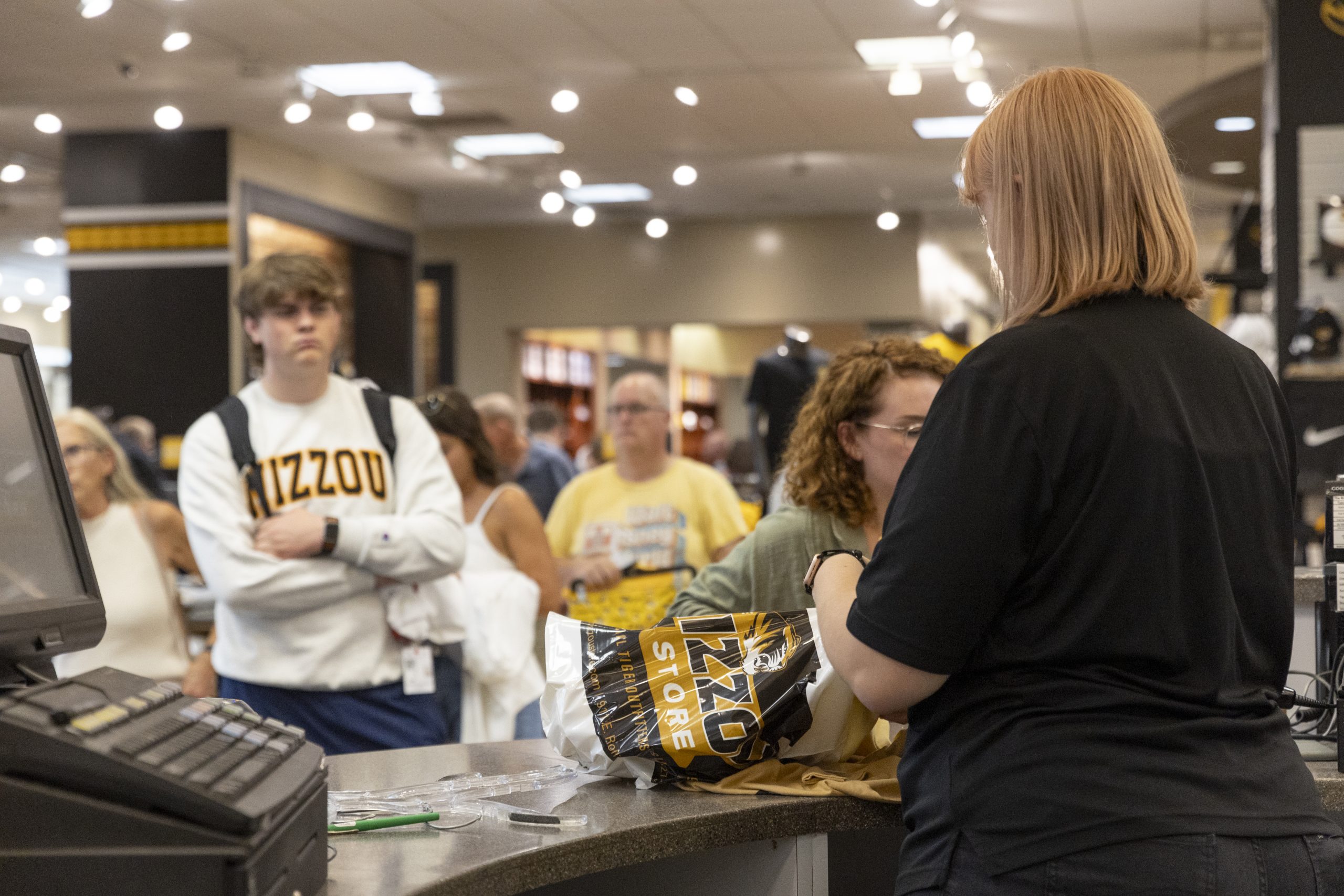 People buy items at The Mizzou Store counter