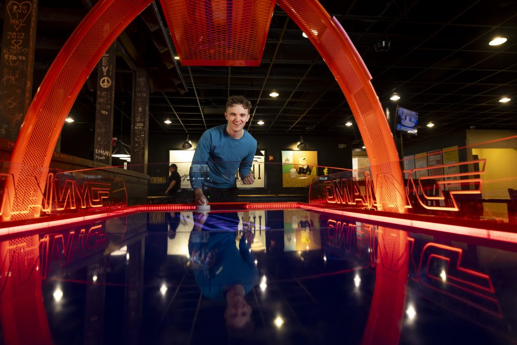 A student plays air hockey in The Shack inside Mort's at the MU Student Center