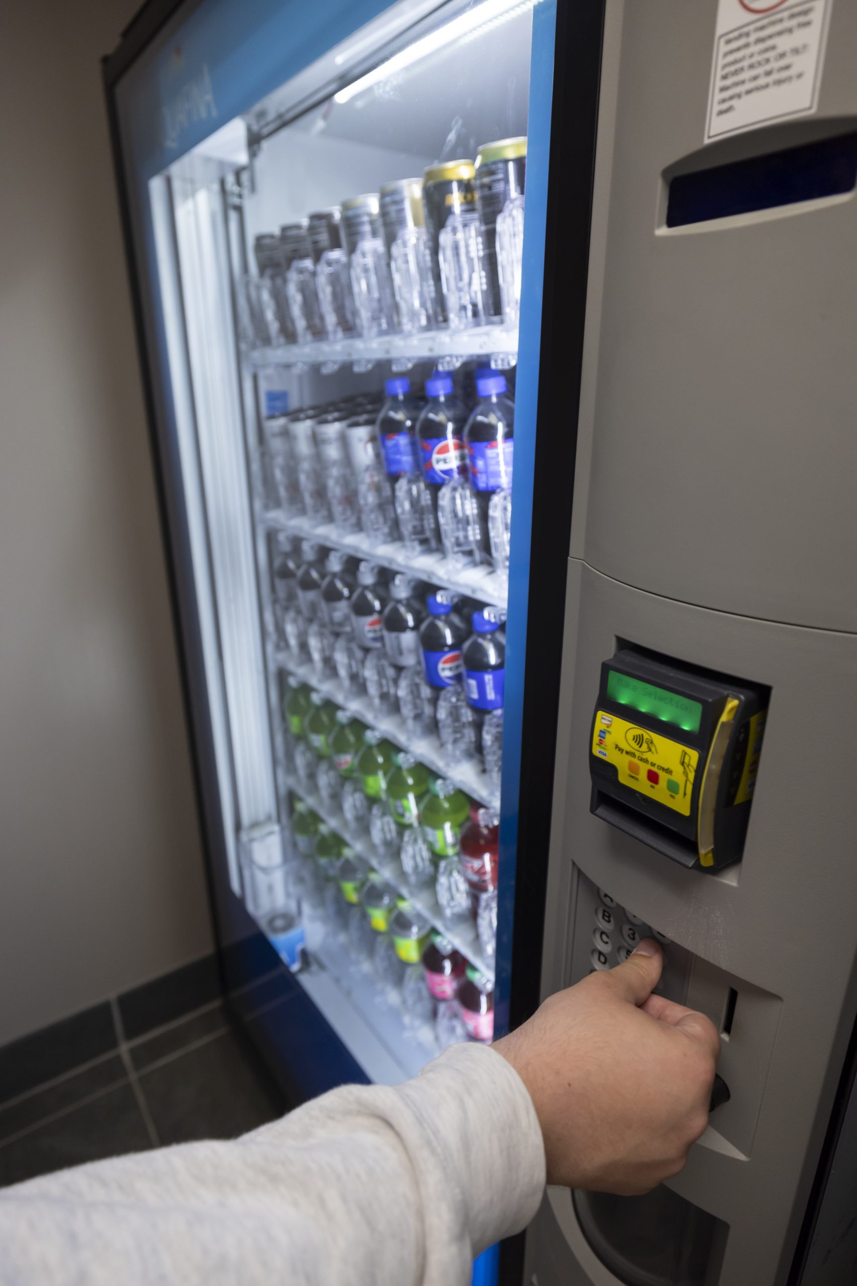 A person uses a vending machine