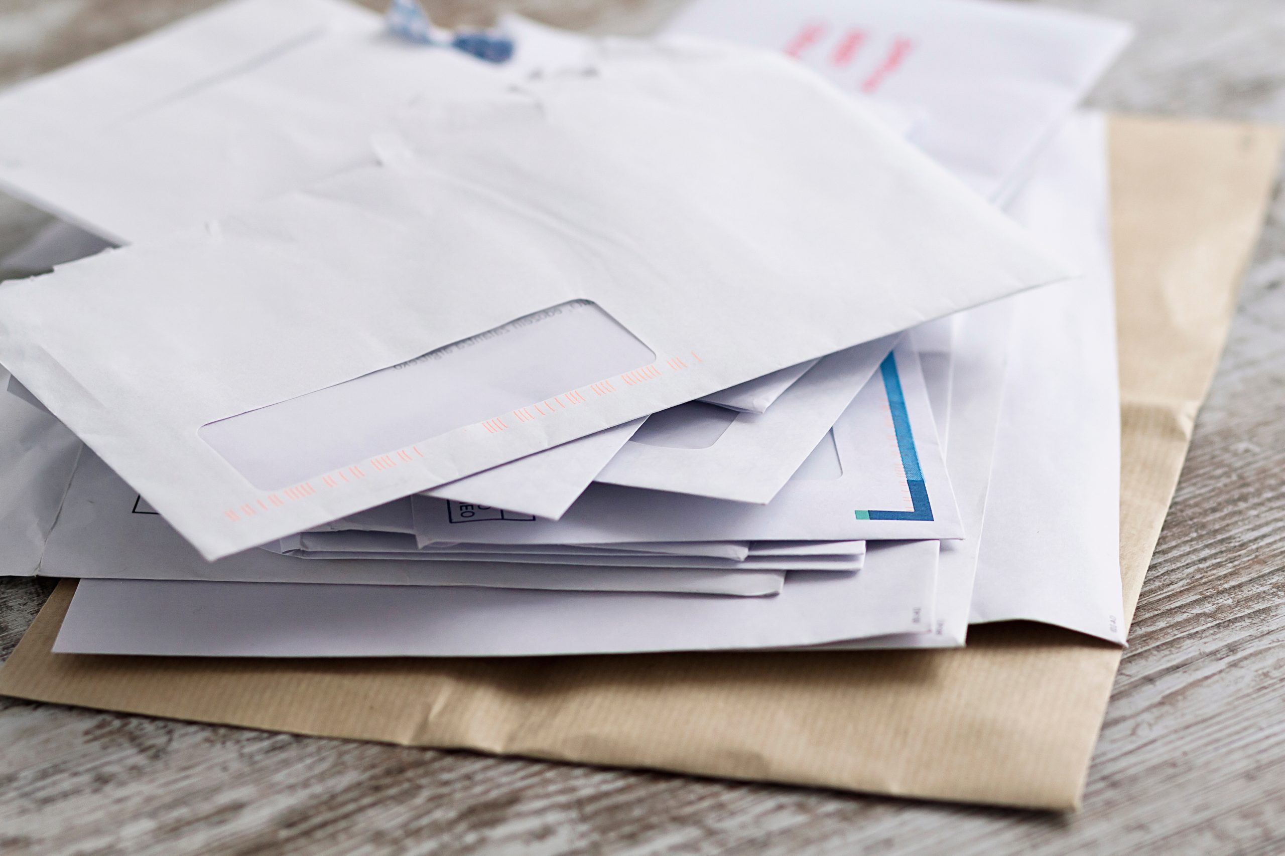 A stack of letters and mail on a table