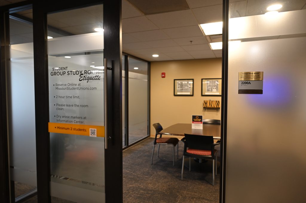 A table, chairs and doorway of a group study room in the MU Student Center
