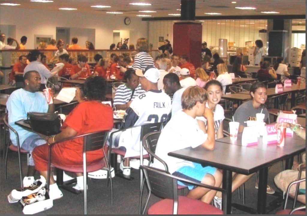 Students gather around tables in the MU Student Center